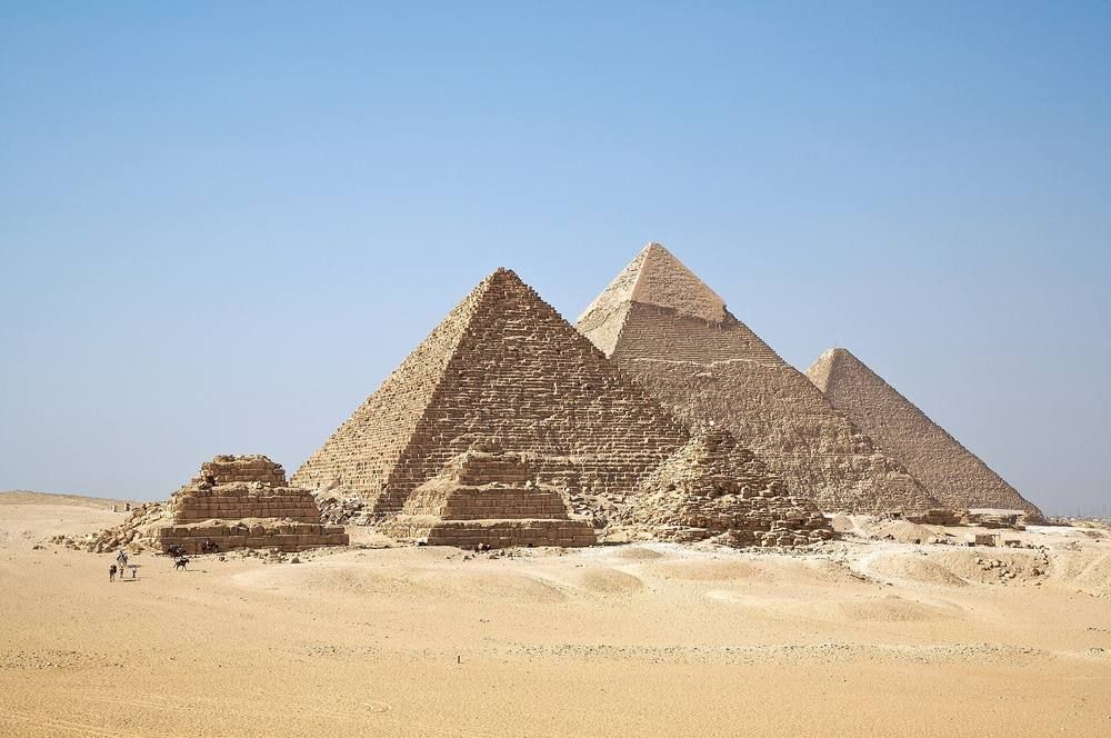 The three large pyramids of Giza and smaller queens' pyramids on the desert plateau.
