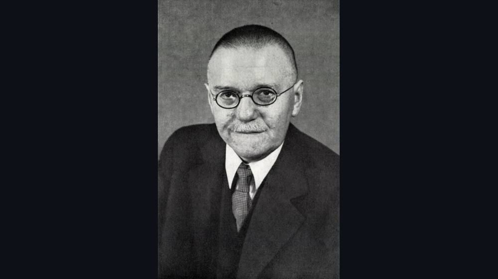 Black and white portrait of a man in a suit.